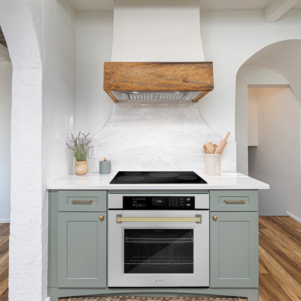 ZLINE Autograph Edition 30 in. Professional True Convection Single Wall Oven with Air Fry and Self Clean in DuraSnow® Stainless Steel with Champagne Bronze Handle (WASSZ-30-CB) in a rustic kitchen below induction cooktop.