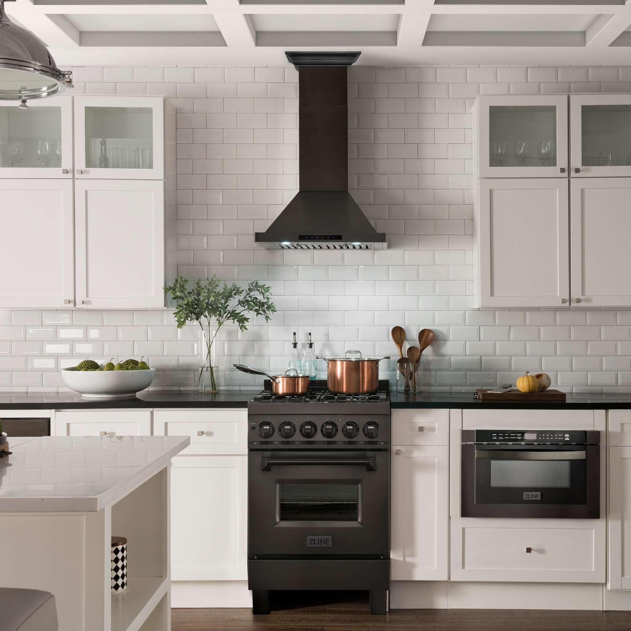 ZLINE black stainless steel wall mount range hood and range in a white farmhouse-style kitchen.