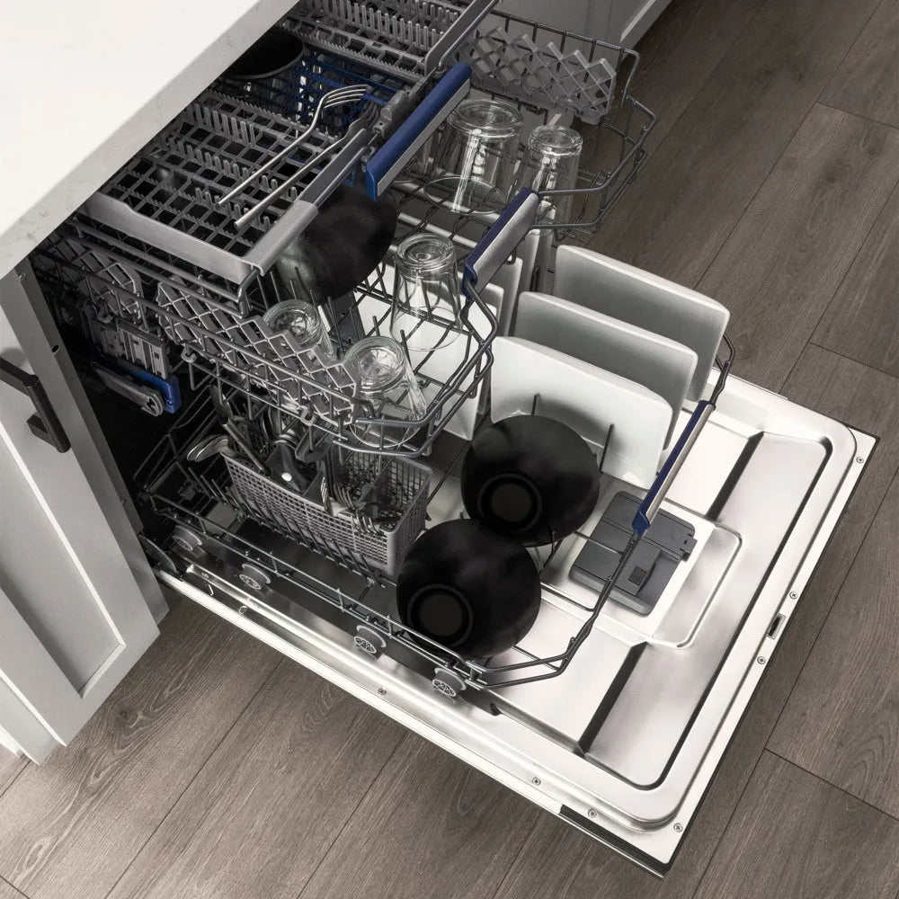ZLINE Autograph Edition 24 in. Tallac Series 3rd Rack Dishwasher with Auto Door Open Drying, 51dBa, Stainless Steel Panel with Polished Gold Handle (DWVZ-304-24-G) with multiple racks loaded with dishes, including bowls, plates, and glassware, shown in a kitchen setting with wood flooring.