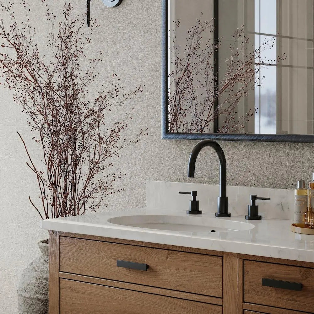 Bathroom vanity with sink, ZLINE Emerald Bay Bath Faucet (EMBY-BF), and decorative branches.