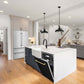 ZLINE Autograph Edition 24 in. Monument Series 3rd Rack Top Touch Control Tall Tub Dishwasher in Black Matte with Polished Gold Handle, 45dBa (DWMTZ-BLM-24-G) built-in to cabinets in a luxury kitchen.