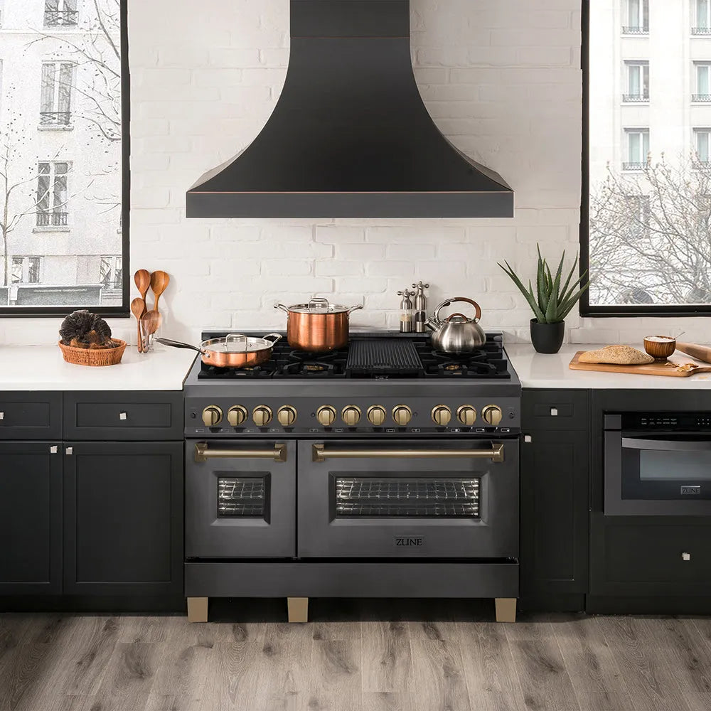 Modern kitchen with a ZLINE Autograph Edition 48 in. 6.0 cu. ft. Legacy Dual Fuel Range with 7 Burner Gas Cooktop and 2 Electric Ovens in Black Stainless Steel and Champagne Bronze Accents (RABZ-48-CB), white countertops, and wooden flooring.