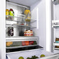 ZLINE Autograph Edition 36 in. 19.6 cu. ft. Built-in 3-Door French Door Refrigerator with Internal Water and Ice Dispenser in Black Stainless Steel with Polished Gold Accents (RBIVZ-BS-36-G) close-up detail, food and drinks inside refrigeration compartment.