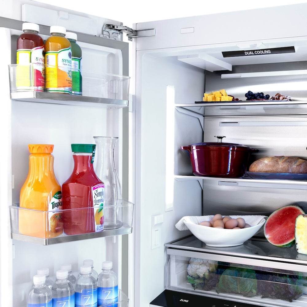 ZLINE Autograph Edition 36 in. 19.6 cu. ft. Panel Ready French Door Built-In Bottom Freezer Refrigerator with Water Dispenser and Ice Maker with Champagne Bronze Accents (RBIVZ-36-CB) open with various food items and drinks inside