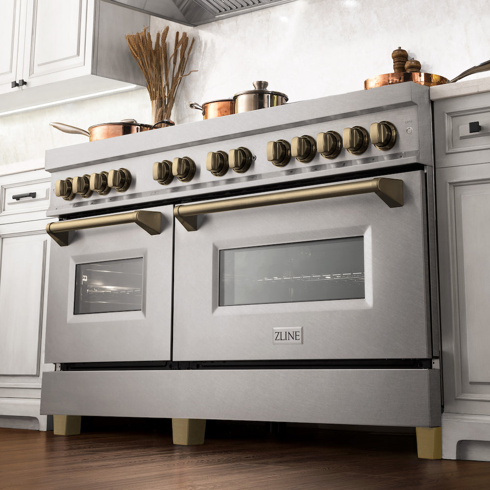 ZLINE Autograph Edition 60 in. 7.4 cu. ft. Dual Fuel Range with Gas Stove and Electric Oven in DuraSnow® Stainless Steel with Champagne Bronze Accents (RASZ-SN-60-CB) from below in a luxury kitchen with cookware on cooktop.