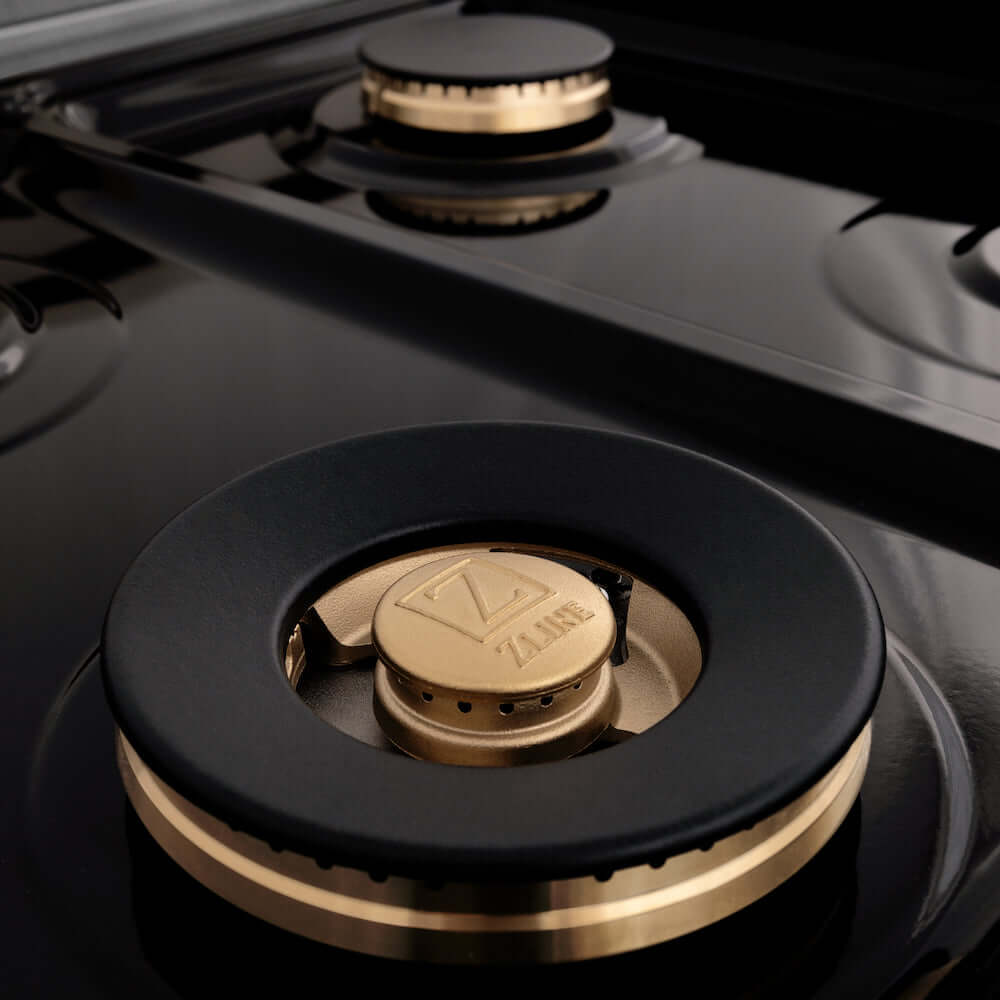 ZLINE Autograph Edition 60 in. 7.4 cu. ft. Dual Fuel Range with Gas Stove and Electric Oven in DuraSnow® Stainless Steel with Matte Black Accents (RASZ-SN-60-MB) brass burners close-up on cooktop without grates.