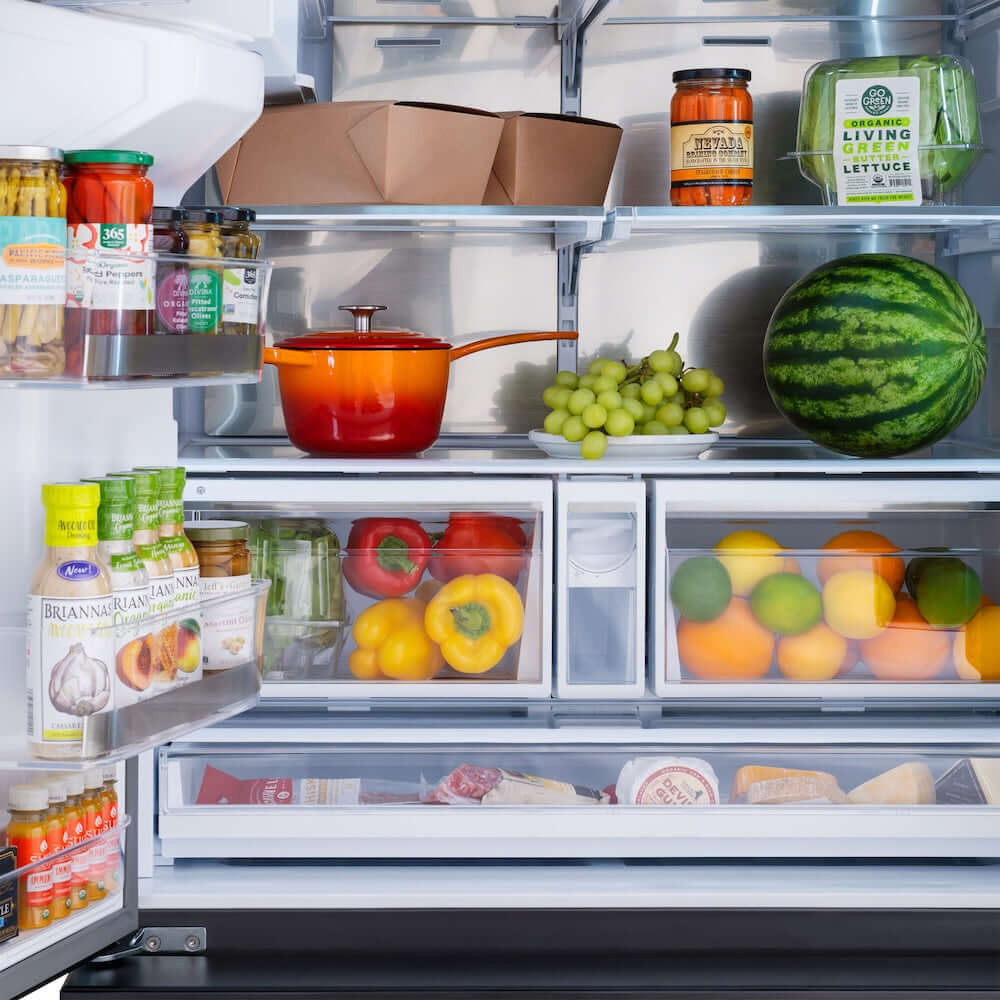 ZLINE Autograph Edition 36 in. 28.9 cu. ft. Standard-Depth French Door External Water Dispenser Refrigerator with Dual Ice Maker in Fingerprint-Resistant Black Stainless Steel and Polished Gold Helix Handles (RSMZ-W-36-BS-KG) front, open, refrigeration compartment with various food items including fruits, vegetables, and packaged goods.