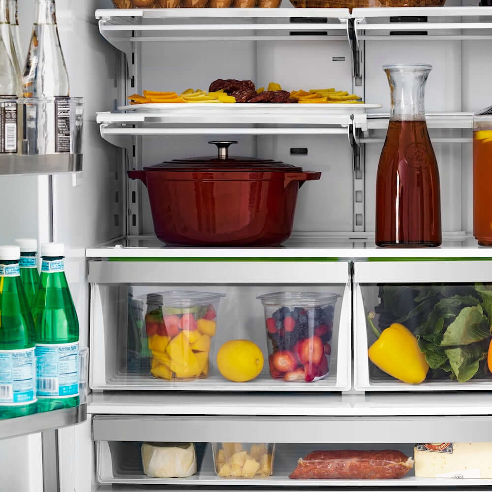 ZLINE Autograph Edition 36 in. 22.5 cu. ft 4-Door French Door Refrigerator with Ice Maker in Stainless Steel with Polished Gold Modern Handles (RFMZ-36-FG) close-up front, food and drinks inside refrigeration compartment.
