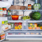 ZLINE Autograph Edition 36 in. 28.9 cu. ft. Standard-Depth French Door External Water Dispenser Refrigerator with Dual Ice Maker in Fingerprint-Resistant Stainless Steel and Matte Black Modern Handles (RSMZ-W-36-FMB) open with various food items, including fruits, vegetables, and packaged goods.
