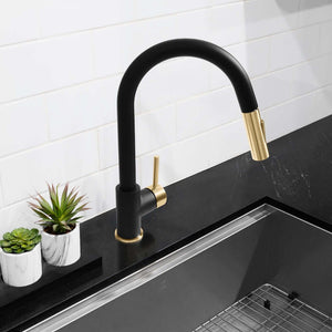ZLINE Autograph Edition Gemini Pull Down Single Handle Kitchen Faucet in Matte Black and Champagne Bronze (GEM-KF-ZMBCB) on a black countertop with white tiled wall background.