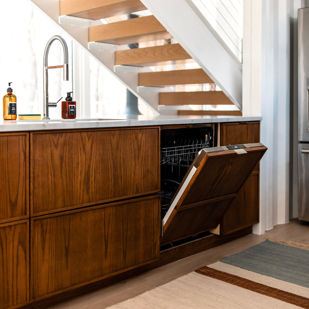 ZLINE Tallac Dishwasher with custom wood-grain panel in a luxury kitchen with door half open.