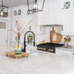 ZLINE Autograph Edition 36 in. Legacy Gas Rangetop with 6 Burners and Porcelain Cooktop in Black Stainless Steel with Polished Gold Accents (RTBZ-36-G) in a luxury cottage-style kitchen from side.