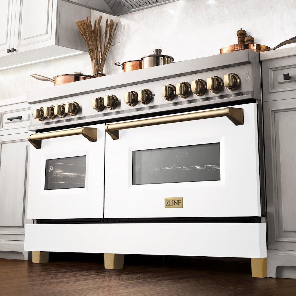 ZLINE Autograph Edition 60 in. 7.4 cu. ft. Legacy Dual Fuel Range with 9 Burner Gas Cooktop and 2 Electric Convection Ovens in Stainless Steel with White Matte Doors and Polished Gold Accents (RAZ-WM-60-G) in a luxury kitchen.