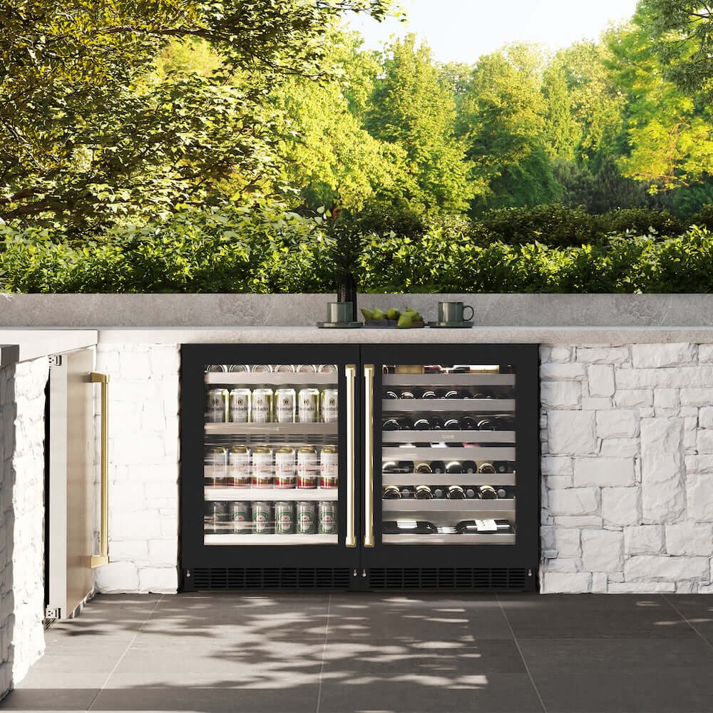 ZLINE Autograph Edition 24 in. Touchstone 151 Can Beverage Fridge With Black Matte Glass Door And Champagne Bronze Handle (RBSOZ-BLM-24-CB) in a luxury outdoor kitchen, front.