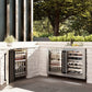 ZLINE Autograph Edition 24 in. Touchstone Dual Zone 44 Bottle Wine Cooler with Satin Stainless Steel Glass Door and Matte Black Handle (RWDOZ-SN-24-MB) side, in an outdoor patio area against a stone wall and greenery.