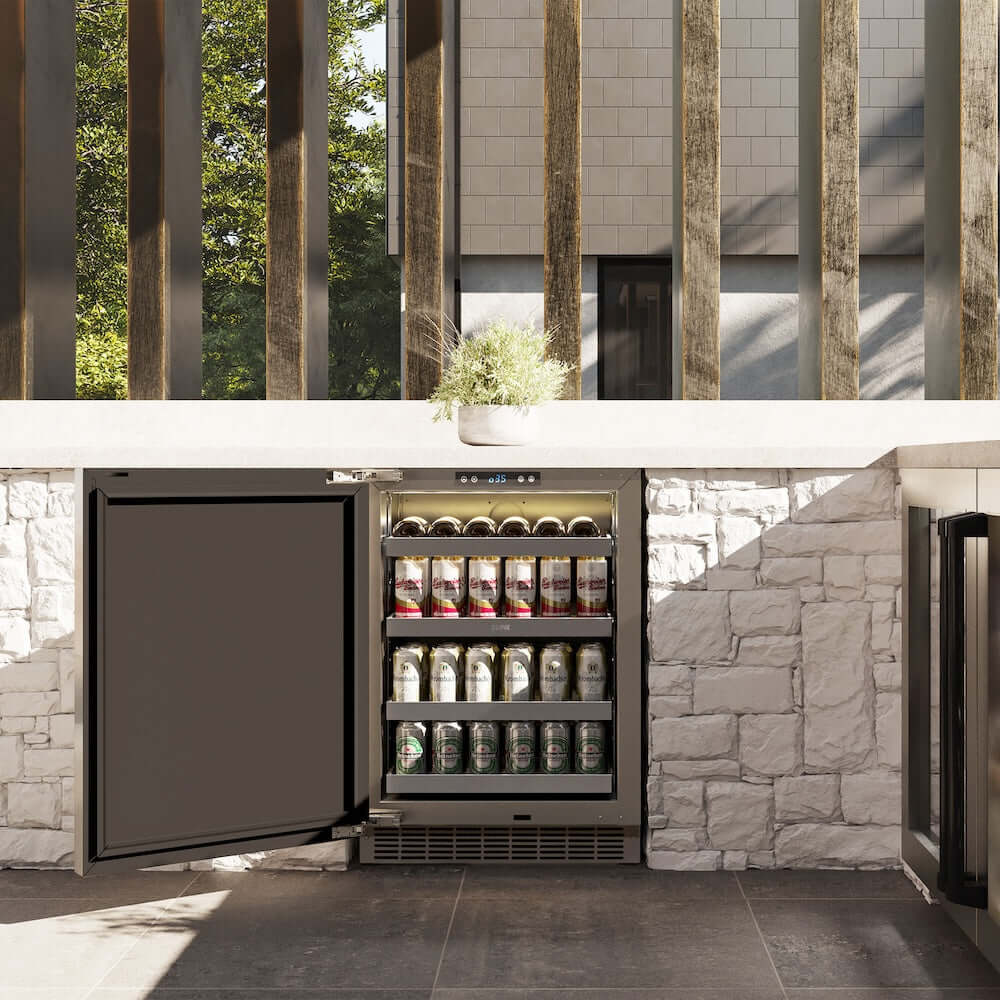 ZLINE Autograph Edition 24 in. Touchstone 151 Can Beverage Fridge With Solid Stainless Steel Door And Matte Black Handle (RBSOZ-ST-24-MB) front, in an outdoor patio area with a matching wine cooler against a stone wall and greenery.