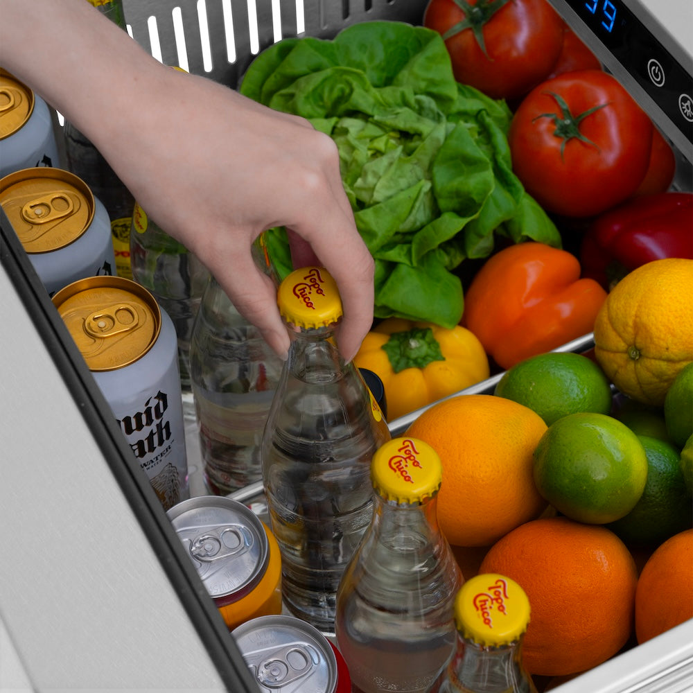 ZLINE Autograph Edition 24 in. Touchstone 168 Can Outdoor-Rated Dual Refrigerator Drawer with Satin Stainless Steel Doors and Matte Black Handles (RDSOZ-SN-24-MB) fruit, vegetables, and drinks in open refrigeration compartment.
