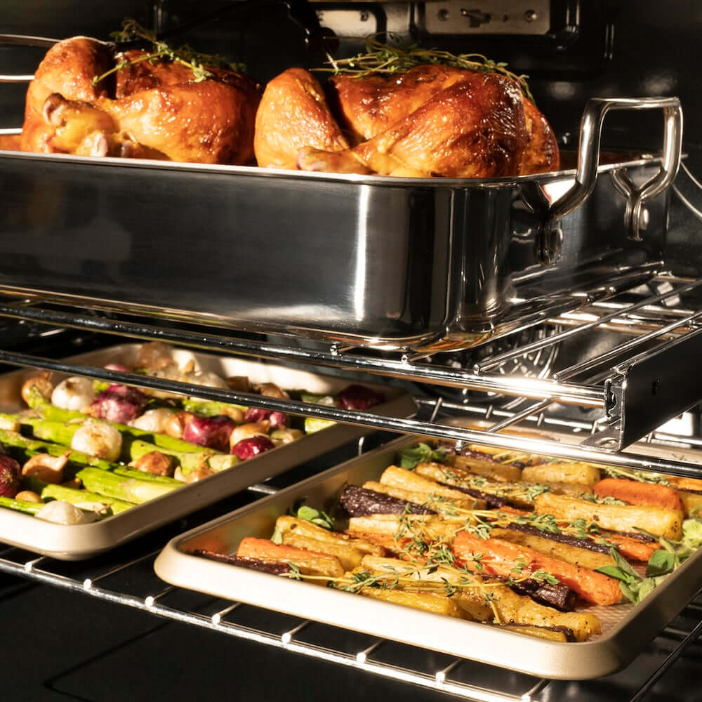 ZLINE Autograph Edition 30 in. Professional True Convection Double Wall Oven with Air Fry and Self Clean in Satin Stainless Steel with Polished Gold Helix Handles (WADSZ-30-KG) roasted chicken and vegetables in oven with a metal roasting pan.