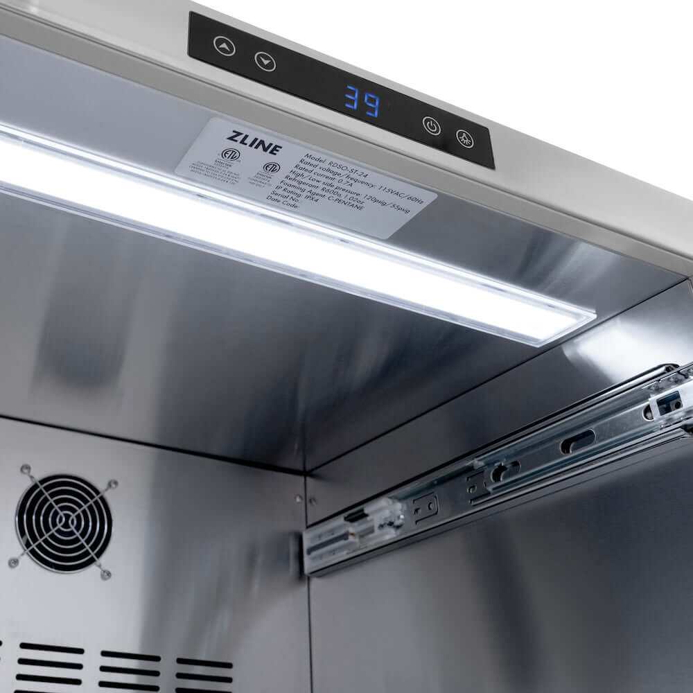 ZLINE Autograph Edition 24 in. Touchstone 168 Can Outdoor-Rated Dual Refrigerator Drawer with Stainless Steel Doors and Matte Black Handles (RDSOZ-ST-24-MB) close-up, LED light in interior.