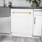 ZLINE Autograph Edition 24 in. Tallac Series 3rd Rack Top Control Built-In Tall Tub Dishwasher in White Matte with Polished Gold Handle, 51dBa (DWVZ-WM-24-G) built-in to white cabinets with granite countertops in a luxury kitchen.