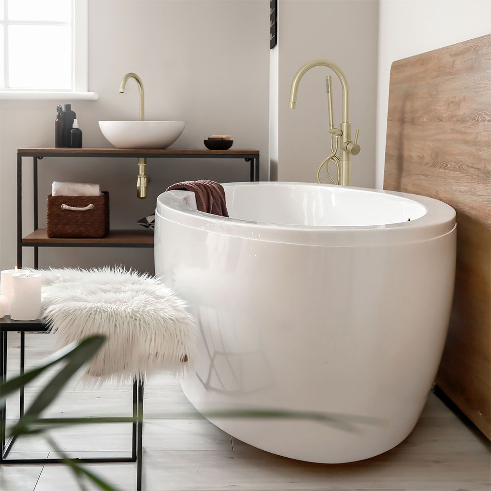 ZLINE Emerald Bay Bath Tub Filler in Champagne Bronze over a white oval bathtub