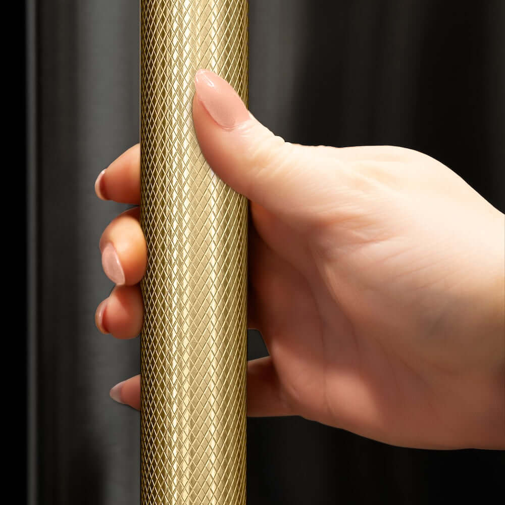 ZLINE Autograph Edition 72 in. 39.6 cu. ft. French Door Built-In Bottom Freezer Refrigerator with Water Dispensers and Ice Makers in Black Stainless Steel with Graphite Gray Interior and Champagne Bronze Helix Handles (GRBITZ-BS72-KCB) hand holding Helix handle showing knurled diamond texture.