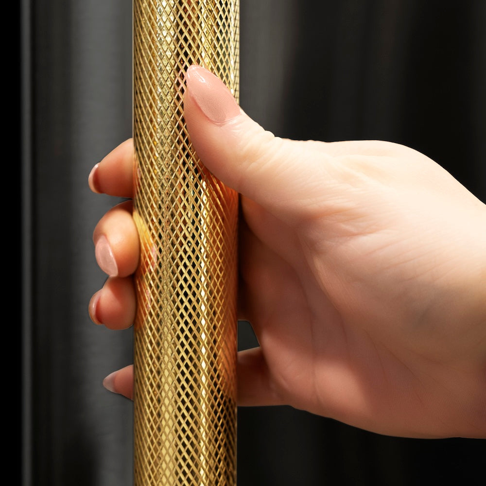 ZLINE Autograph Edition 15 in. Touchstone Clear Cube Ice Maker with Drain Pump and Black Stainless Steel Door with Polished Gold Helix Handle (ICCDZ-BS-15-KG) hand holding Helix handle showing knurled diamond texture.