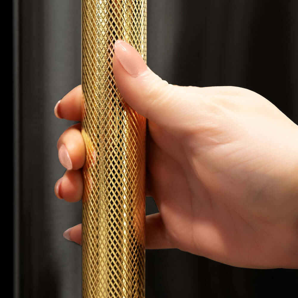 ZLINE Autograph Edition 36 in. 19.6 cu. ft. French Door Built-In Bottom Freezer Refrigerator with Water Dispenser and Ice Maker in Black Stainless Steel with Graphite Gray Interior and Polished Gold Helix Handles (GRBIVZ-BS36KG) hand holding Helix handle showing knurled diamond texture.