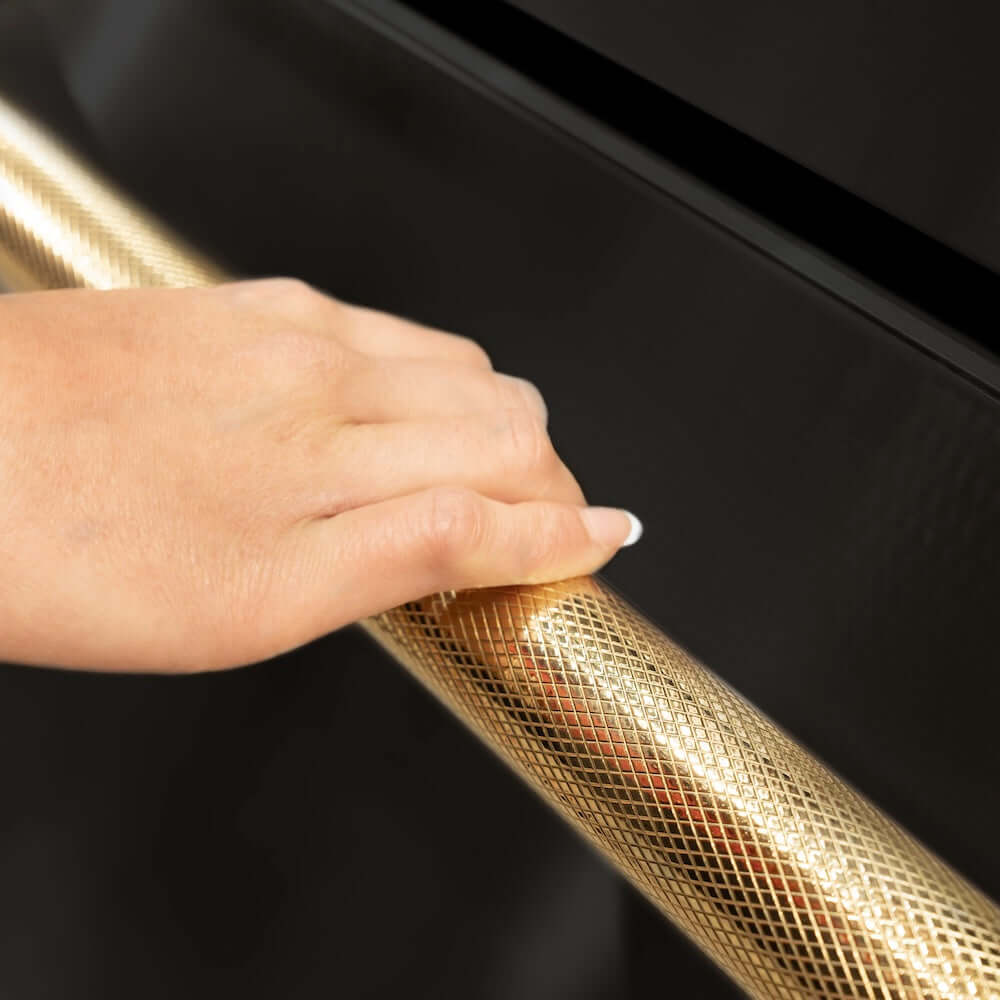 ZLINE Autograph Edition 36 in. 28.9 cu. ft. Standard-Depth French Door External Water Dispenser Refrigerator with Dual Ice Maker in Fingerprint-Resistant Black Stainless Steel and Polished Gold Helix Handles (RSMZ-W-36-BS-KG) hand holding Helix handle showing knurled diamond texture.