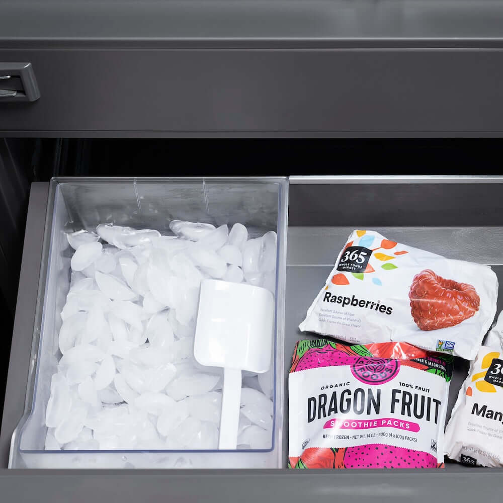 ZLINE Autograph Edition 30 in. 16.1 cu. ft. Built-In Bottom Freezer Refrigerator with Water Dispenser and Ice Maker in Black Stainless Steel with Graphite Gray Interior and Polished Gold Helix Handles (GRBIVZ-BS30KG) frozen food packages including raspberries and dragon fruit in bottom freezer drawer with ice bin.