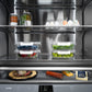 ZLINE Autograph Edition 36 in. 19.6 cu. ft. French Door Built-In Bottom Freezer Refrigerator with Water Dispenser and Ice Maker in Stainless Steel with Graphite Gray Interior and Champagne Bronze Accents (GRBIVZ-304-36CB) close-up, food inside refrigeration compartment.
