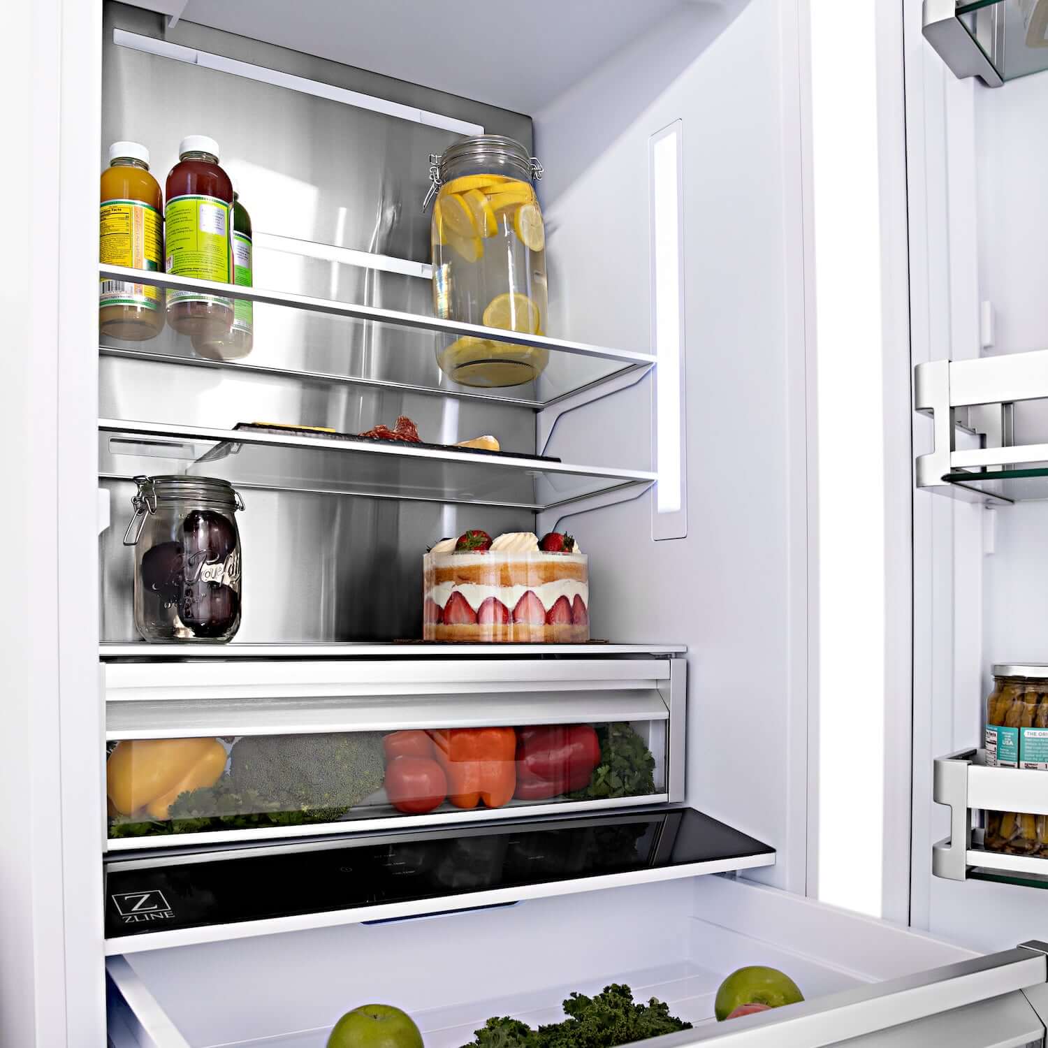 Food on shelves and in drawers inside ZLINE built-in refrigerator. 
