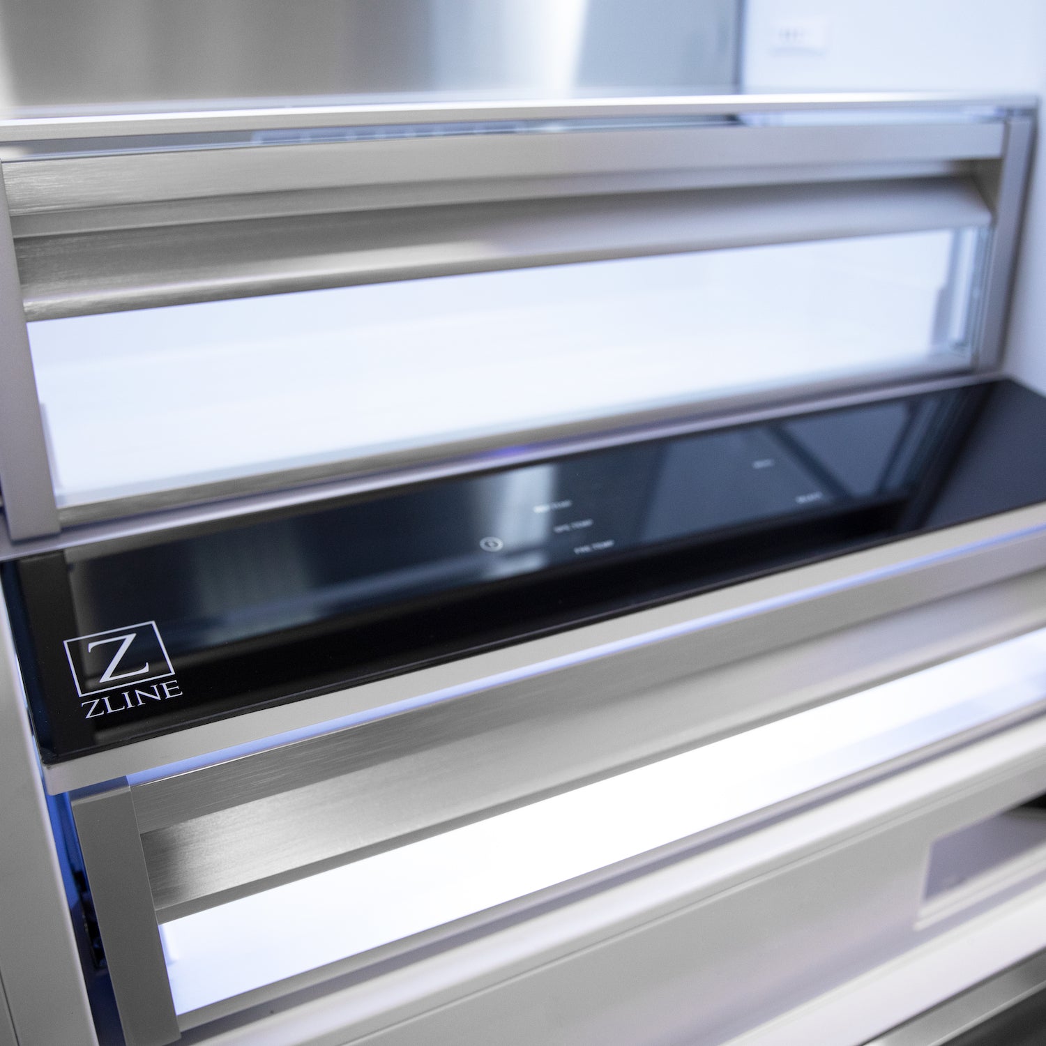 Drawers inside ZLINE built-in refrigerator above temperature controls.