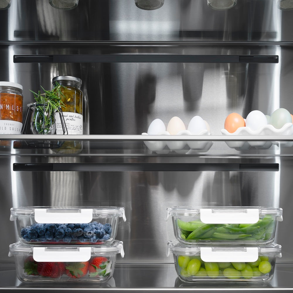 ZLINE Autograph Edition 36 in. 19.6 cu. ft. French Door Built-In Bottom Freezer Refrigerator with Water Dispenser and Ice Maker in Stainless Steel with Stainless Steel Interior and Champagne Bronze Helix Handles (SRBIVZ-30436KCB) refrigeration compartment with food storage containers on a shelf.