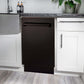 ZLINE 18 in. Tallac Series 3rd Rack Top Control Built-In Dishwasher in Oil Rubbed Bronze with Stainless Steel Tub, 51dBa (DWV-ORB-18) built-in to white cabinets with granite countertops in a luxury kitchen.