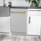 ZLINE Autograph Edition 18 in. Tallac Series 3rd Rack Top Control Built-In Dishwasher in Stainless Steel with Champagne Bronze Handle, 51dBa (DWVZ-304-18-CB) built-in to white cabinets with granite countertops in a luxury kitchen.