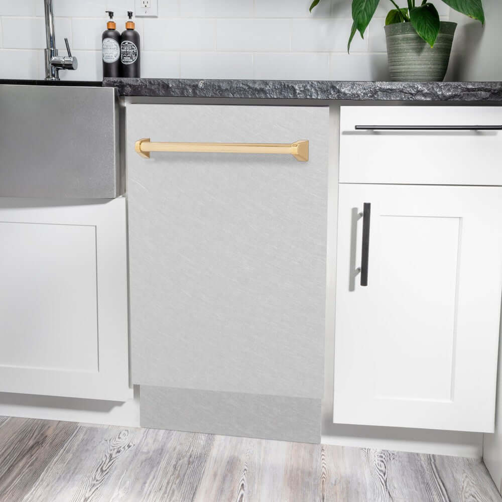 ZLINE Autograph Edition 18 in. Tallac Series 3rd Rack Top Control Built-In Dishwasher in Fingerprint Resistant Stainless Steel with Polished Gold Handle, 51dBa (DWVZ-SN-18-G) built-in to white cabinets with granite countertops in a luxury kitchen.