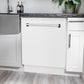 ZLINE 24 in. Tallac Series 3rd Rack Tall Tub Dishwasher in White Matte with Stainless Steel Tub, 51dBa (DWV-WM-24) built-in to white cabinets with granite countertops in a luxury kitchen.