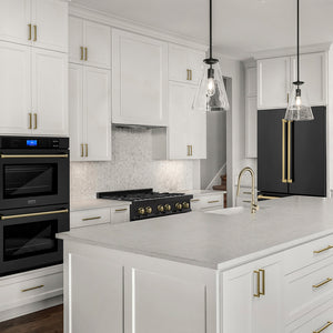 ZLINE Autograph Edition 36 in. 22.5 cu. ft. Counter-Depth French Door Refrigerator with Ice Maker in Fingerprint-Resistant Black Stainless Steel and Champagne Bronze Traditional Handles (RFMZ-36-BS-CB) in a kitchen with white cabinets, black appliances, and a marble countertop.
