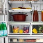 ZLINE Autograph Edition 36 in. 22.5 cu. ft. Counter-Depth French Door Refrigerator with Ice Maker in Fingerprint-Resistant Black Stainless Steel and Champagne Bronze Traditional Handles (RFMZ-36-BS-CB) food on shelves inside refrigeration compartment.