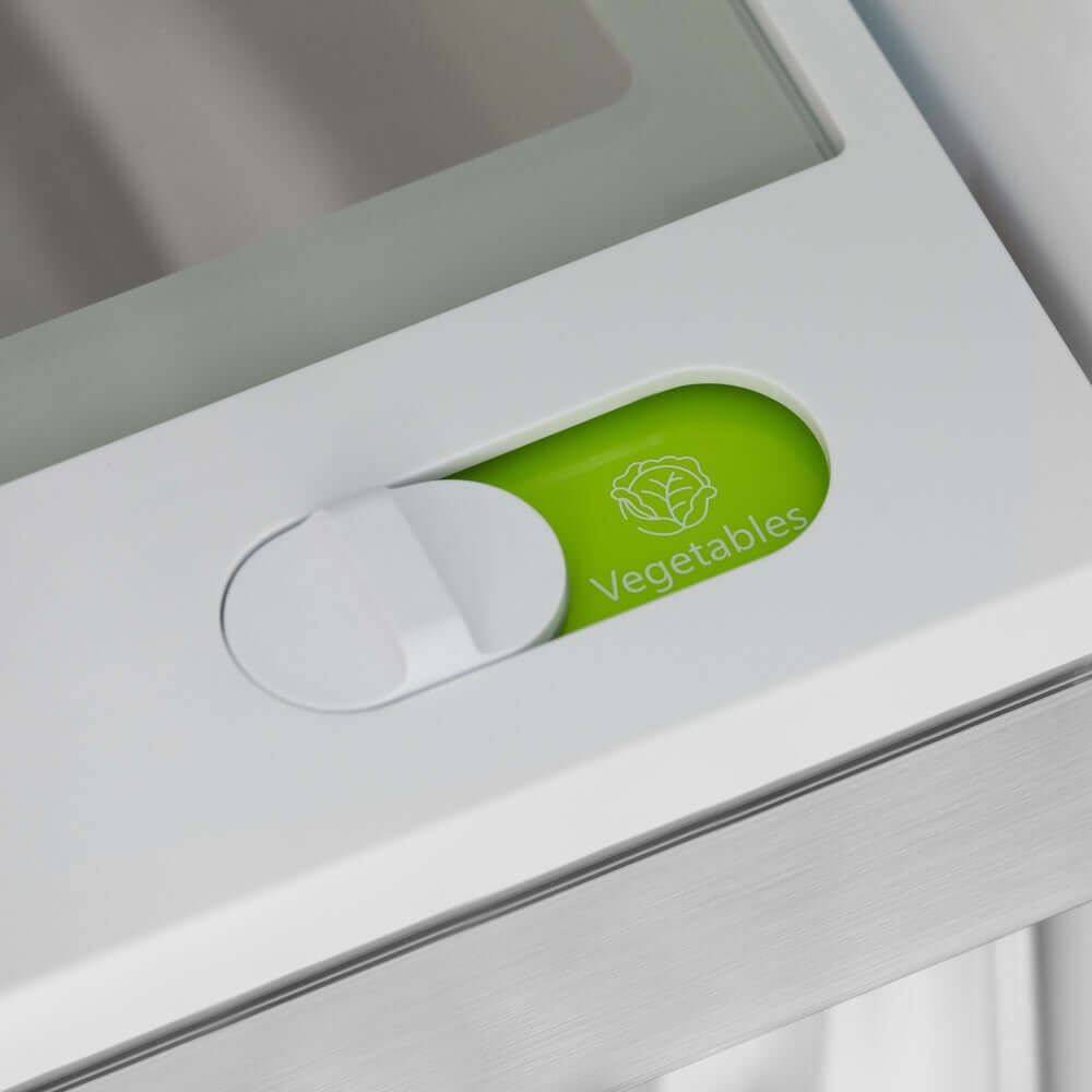 ZLINE Autograph Edition 36 in. 22.5 cu. ft. Counter-Depth French Door Refrigerator with Ice Maker in Fingerprint-Resistant Black Stainless Steel and Champagne Bronze Helix Handles (RFMZ-36-BS-KCB) green label on Flex Drawer labeled 'Vegetables' inside refrigeration compartment.