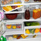 ZLINE Autograph Edition 36 in. 22.5 cu. ft. Counter-Depth French Door Refrigerator with Ice Maker in Fingerprint-Resistant Stainless Steel with Polished Gold Traditional Handles (RFMZ-36-G) food on shelves inside refrigeration compartment.
