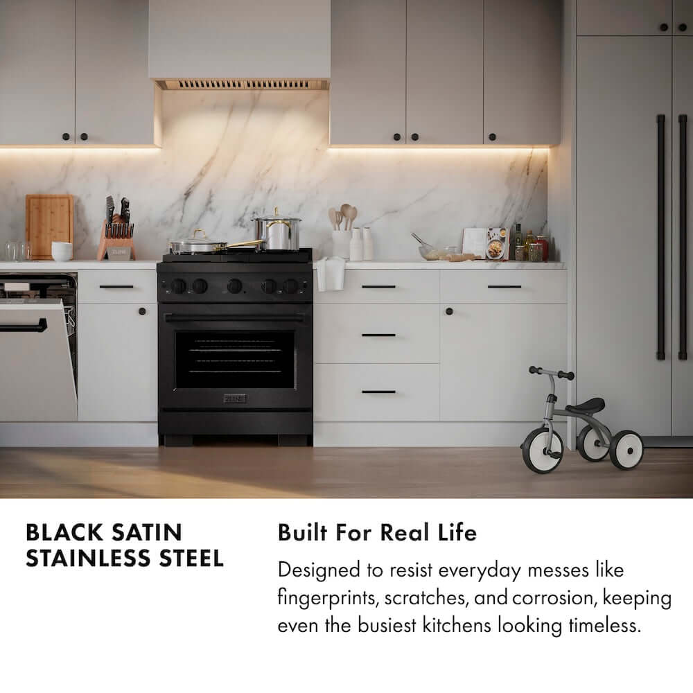 Black Satin Stainless Steel infographic. Image: Modern kitchen with black satin stainless steel appliances and white cabinets. Text: Built for Real Life. Designed to resist everyday messes like fingerprints, scratches, and corrosion, keeping even the busiest kitchens looking timeless.