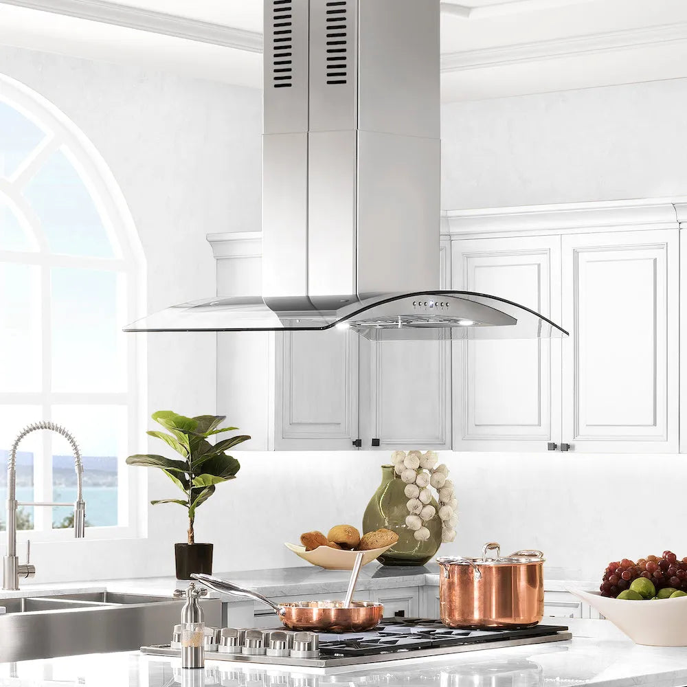 Luxury kitchen with stainless steel range hood, copper pots, and white cabinets.