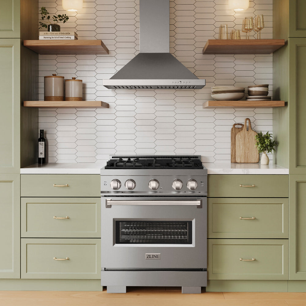 ZLINE Convertible Vent Wall Mount Range Hood in Stainless Steel (KB) in a kitchen above a stainless steel range and green cabinets.
