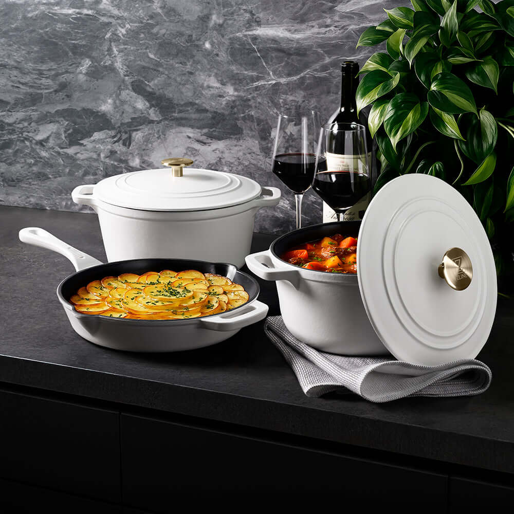 ZLINE 5-Piece Enameled Cast Iron Cookware Set in White Matte (CWSETS-WM-5) on a dark counter with wine glasses.