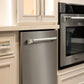 ZLINE Autograph Edition 24 in. Monument Series 3rd Rack Top Touch Control Tall Tub Dishwasher in Stainless Steel with Polished Nickel Helix Handle, 45dBa (DWMTZ-30424-KPN) and wall oven in a kitchen setting with white cabinets with matching knurled cabinet pulls.