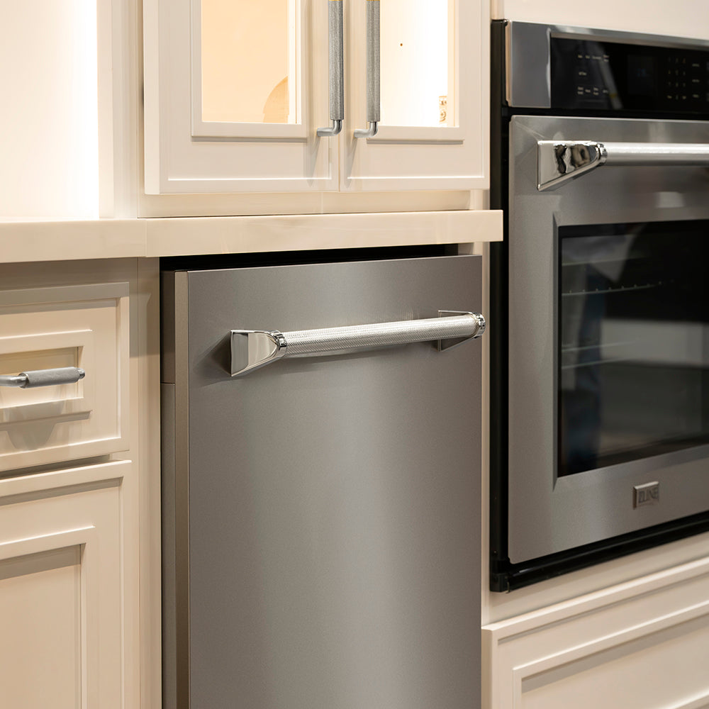 ZLINE Autograph Edition 24 in. Monument Series 3rd Rack Dishwasher with Auto Door Open Drying, 44dBa, Stainless Steel Panel with Polished Nickel Helix Handle (DWMTZ-30424-KPN) in a kitchen setting.