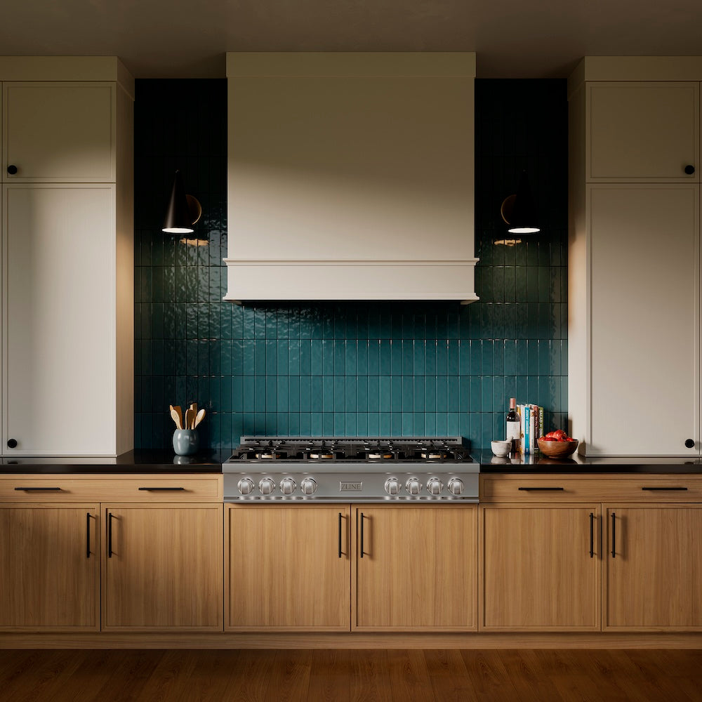 ZLINE 48 in. Classic Gas Rangetop with 8 Burner DuoPro™ Cooktop in Stainless Steel (PCRT48) in a kitchen with wooden cabinets, a custom range hood, and a blue-green tiled backsplash, front.