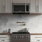 ZLINE 30 in. Stainless Steel Over the Range Convection Microwave Oven with Traditional Handle (MWO-OTR-H-30) in a kitchen with marble backsplash and gold fixtures.